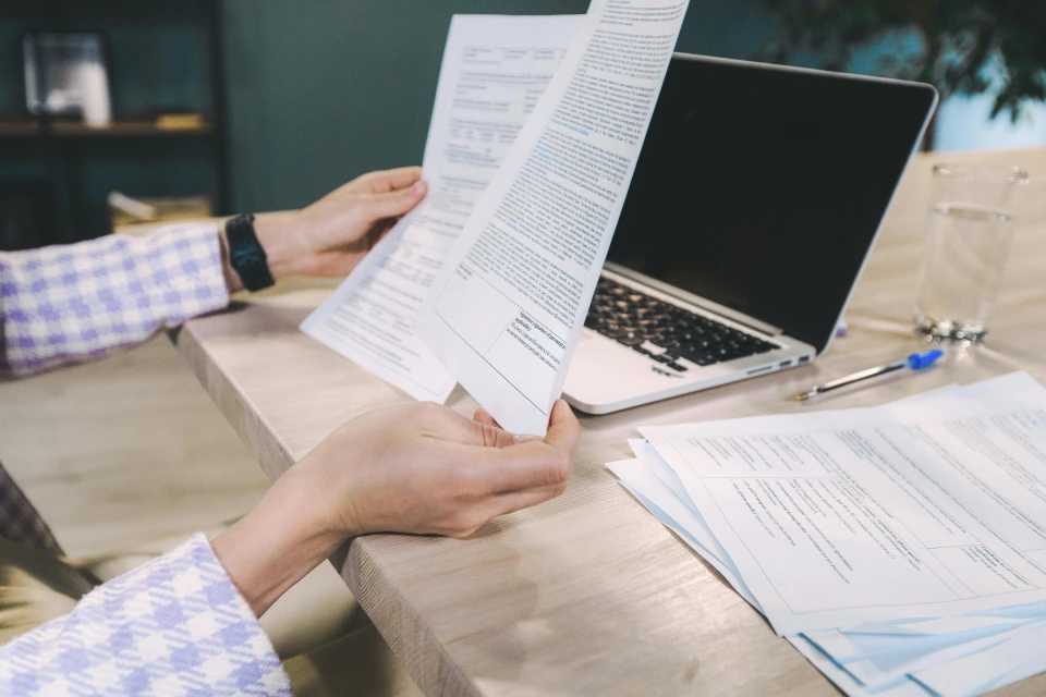 Reviewing and organising documents during a business meeting.