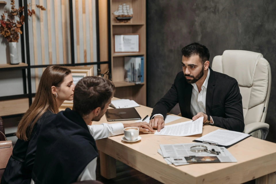 Advisor explaining financial details to a couple.